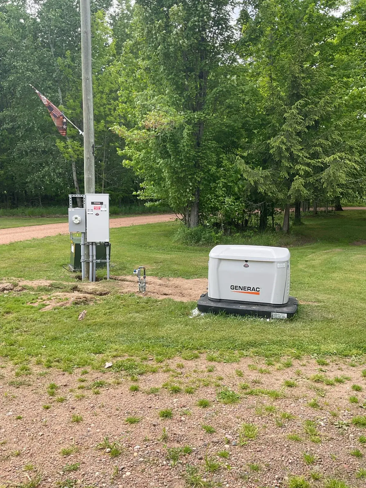 After — standby generator set on a pad with the transfer gear at the pole