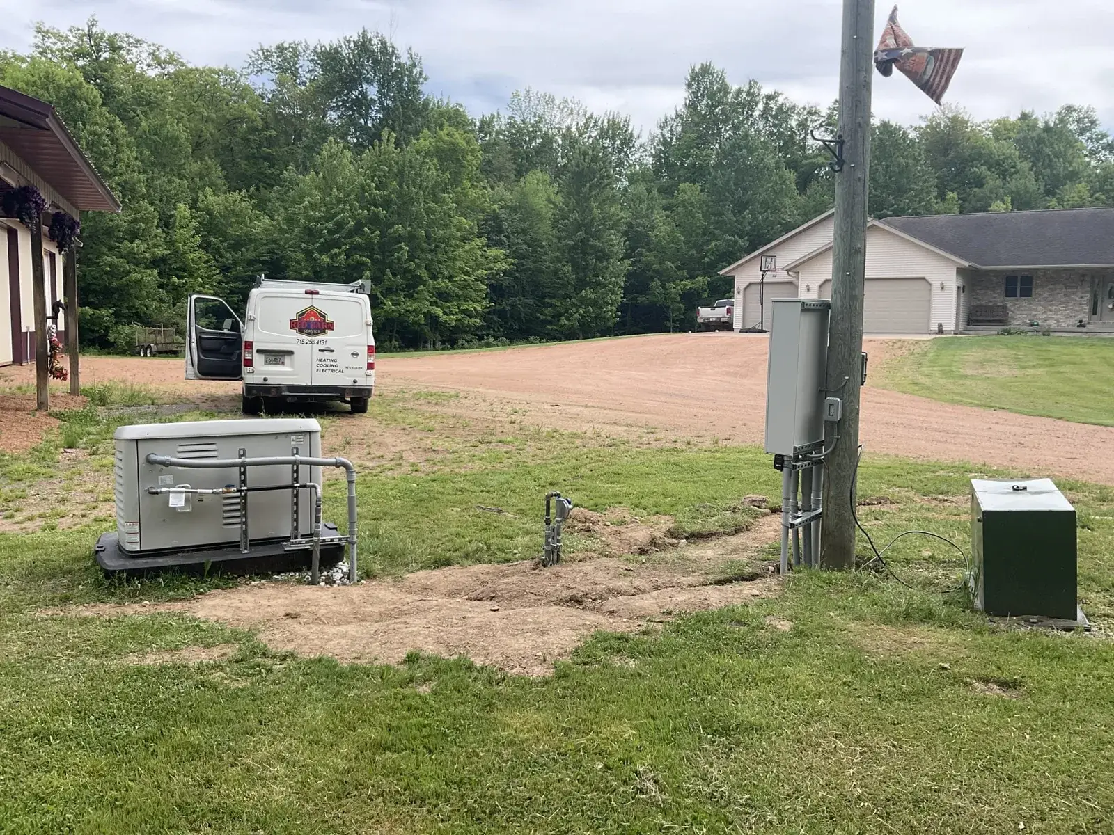 After — the finished install from the driveway, service gear and generator in line