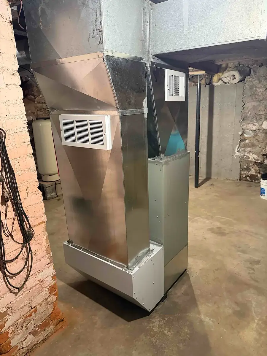 After — new supply plenum and return drop fabricated to fit the space - Colby, WI