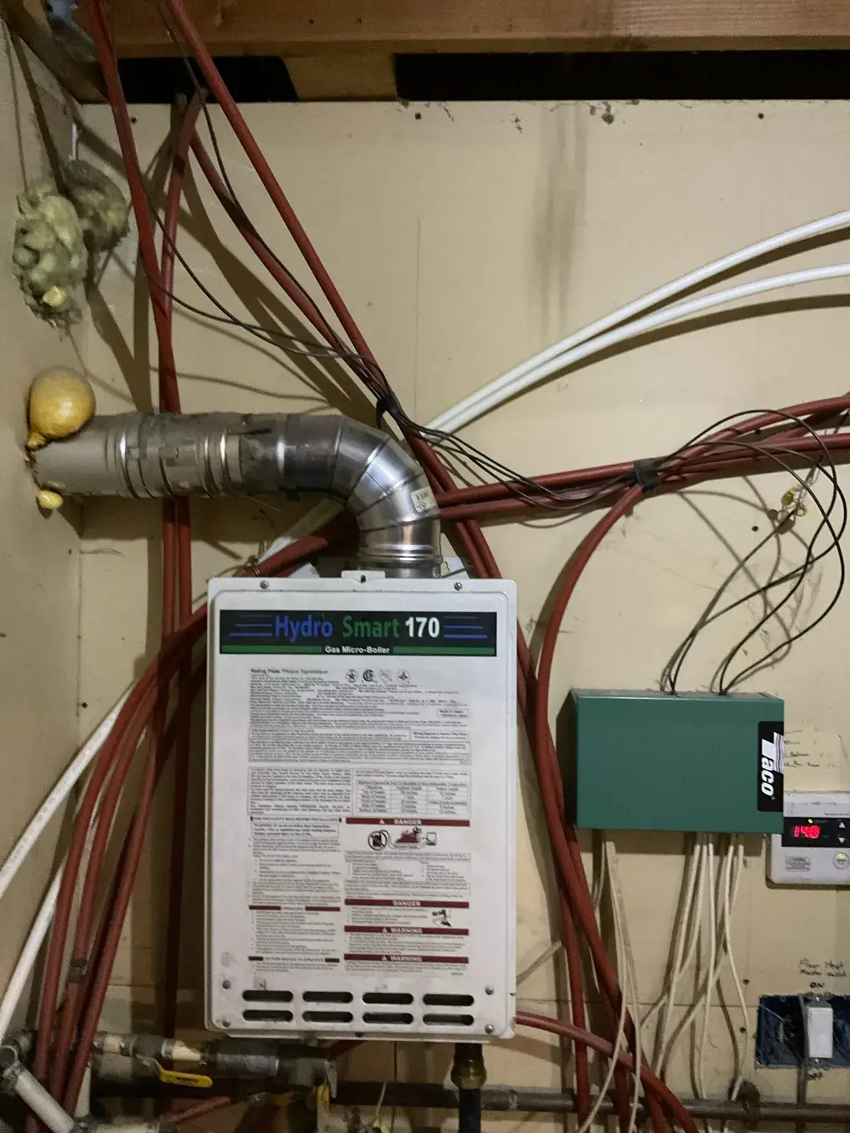Before — the failing gas micro-boiler that was heating the house