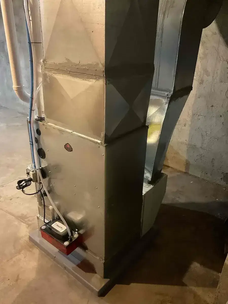 Side view of a new furnace install, condensate pump and drain lines finished