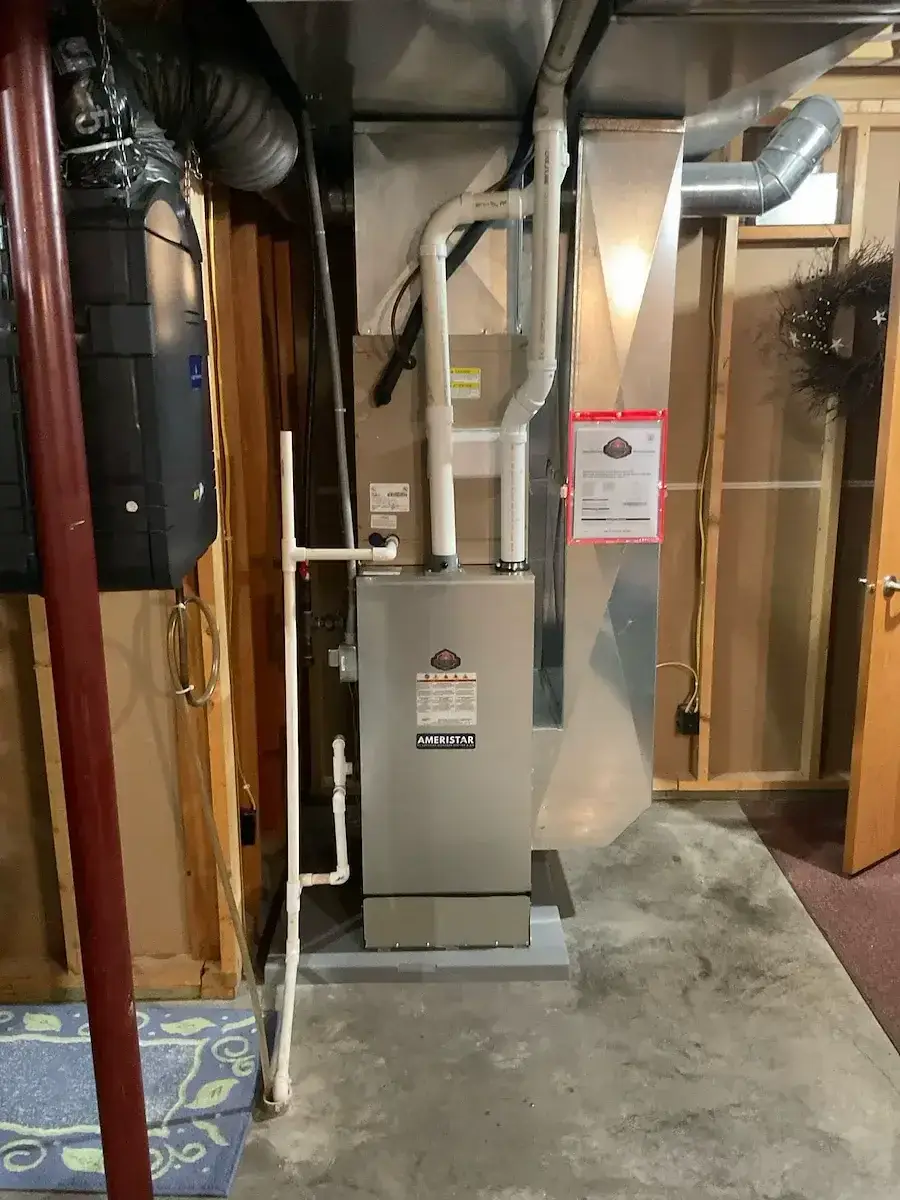 After — the replacement furnace in place, venting and gas reconnected