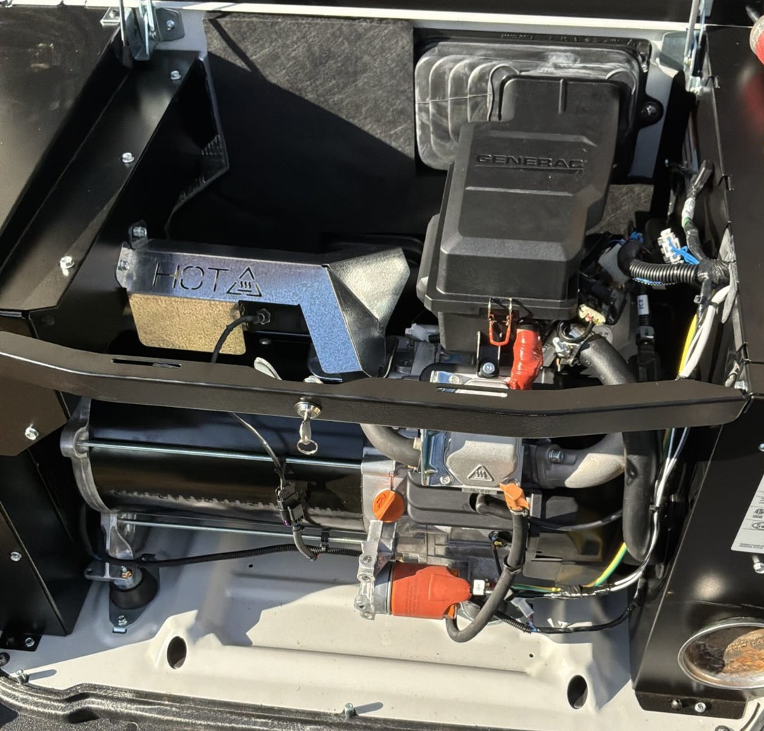 Inside the engine bay of a new Generac standby generator with the cold weather kit installed