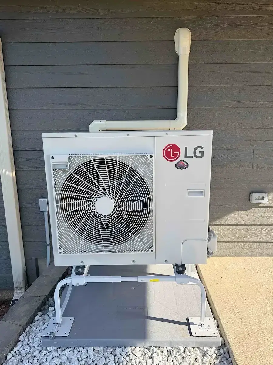 After — the outdoor unit set on a wall stand to keep it clear of snow