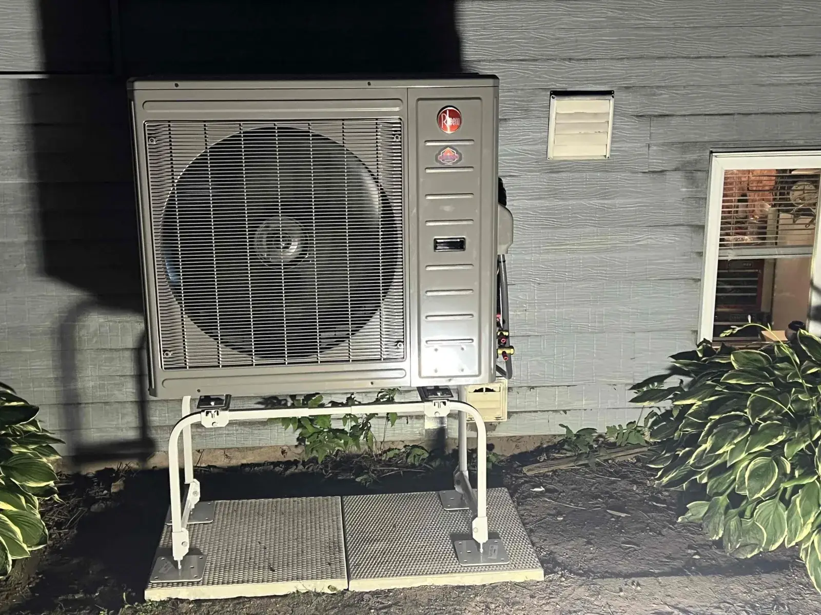 After — new heat pump mounted on a stand to keep it above the snow