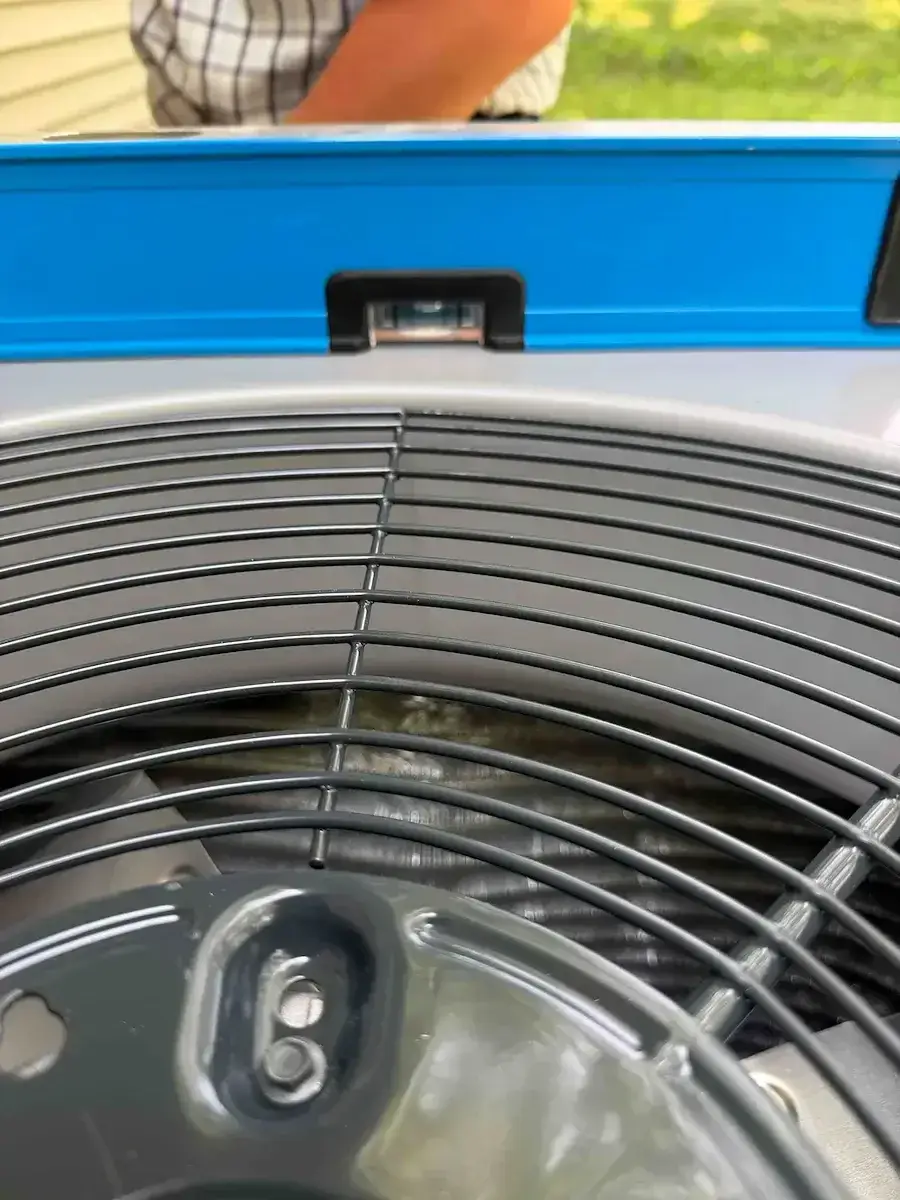 Level laid across the top of the unit — small detail, longer compressor life