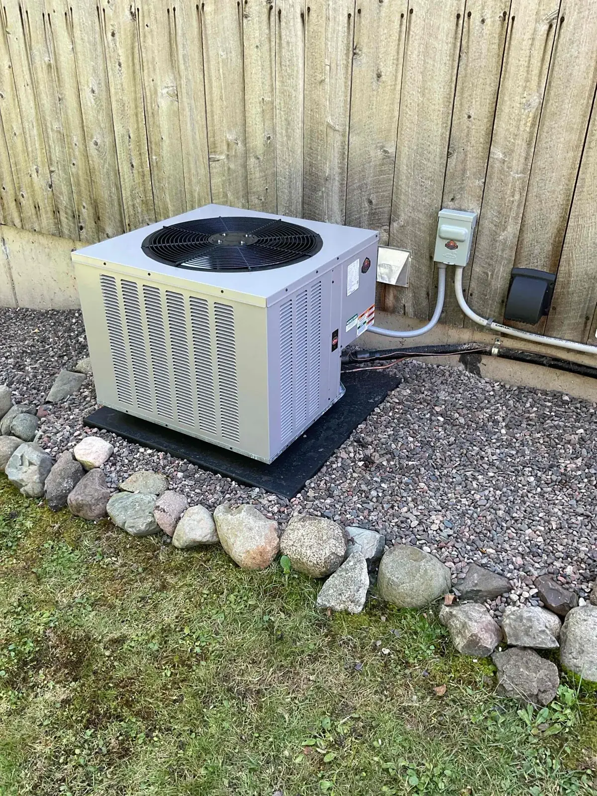 New condenser set on a pad with a new outdoor disconnect