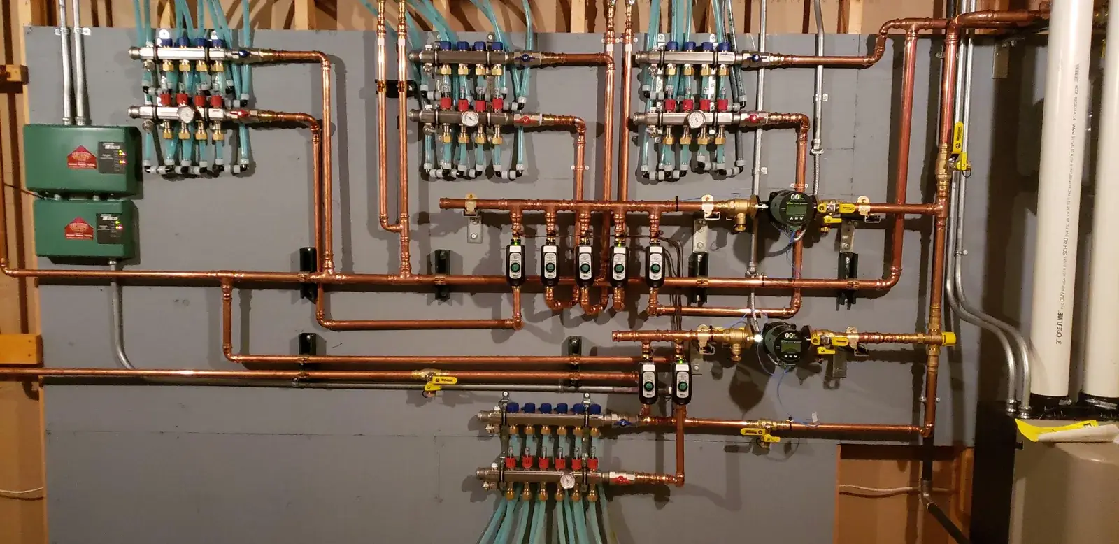 Full radiant manifold wall — multi-zone in-floor heat, all copper, all labeled