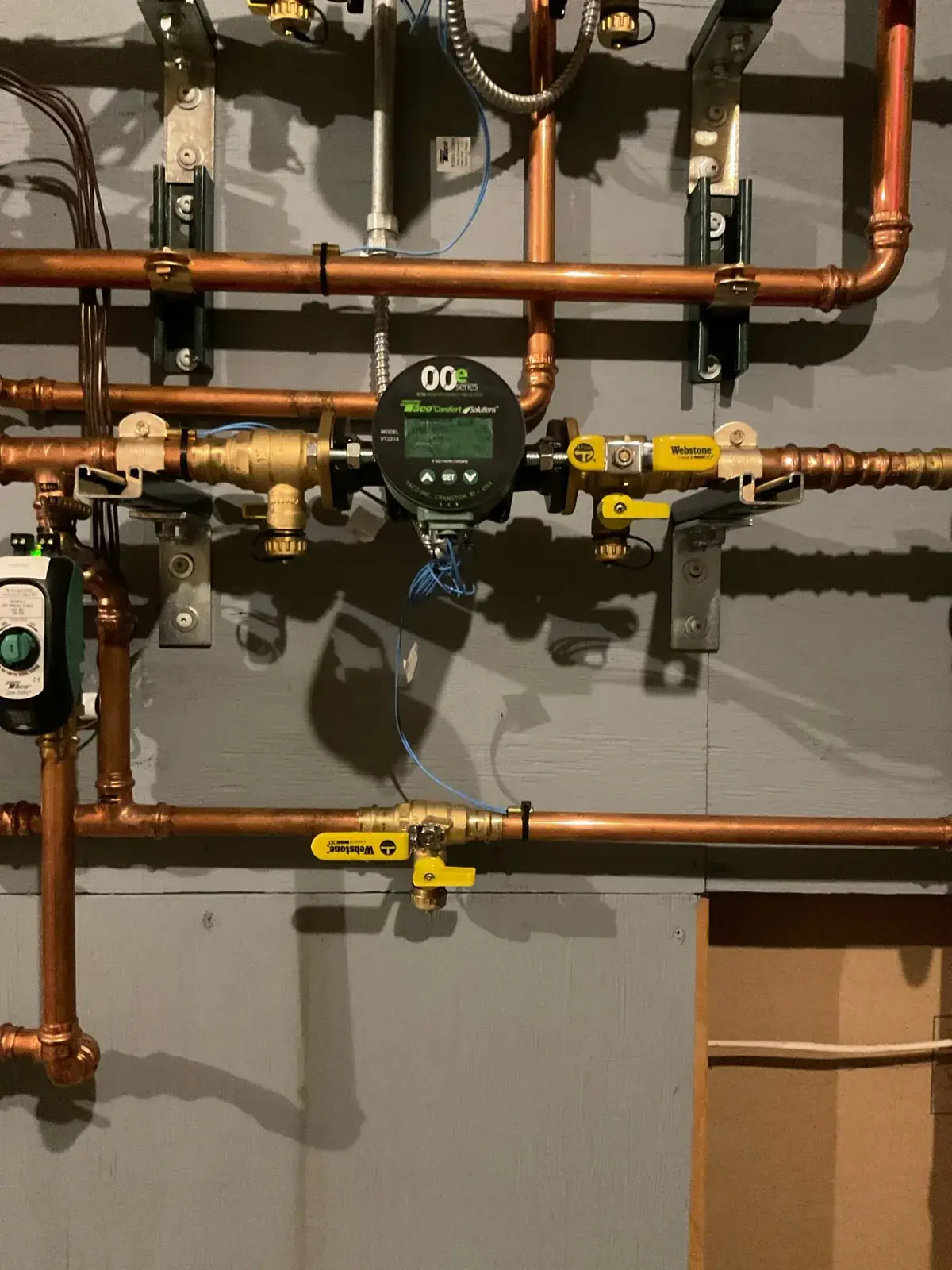 Closeup of a variable-speed circulator and isolation valves on the primary loop