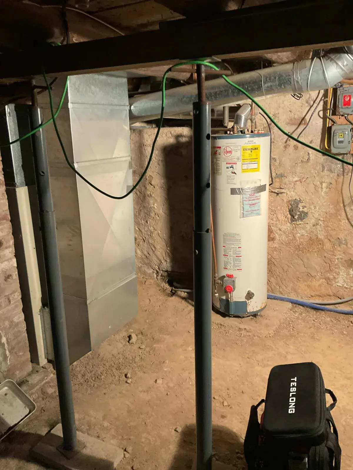 Before — the original basement mechanical setup before our work