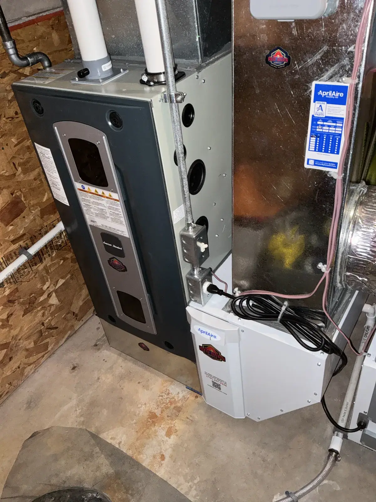 After — new furnace with the AprilAire filter cabinet labeled with our service number