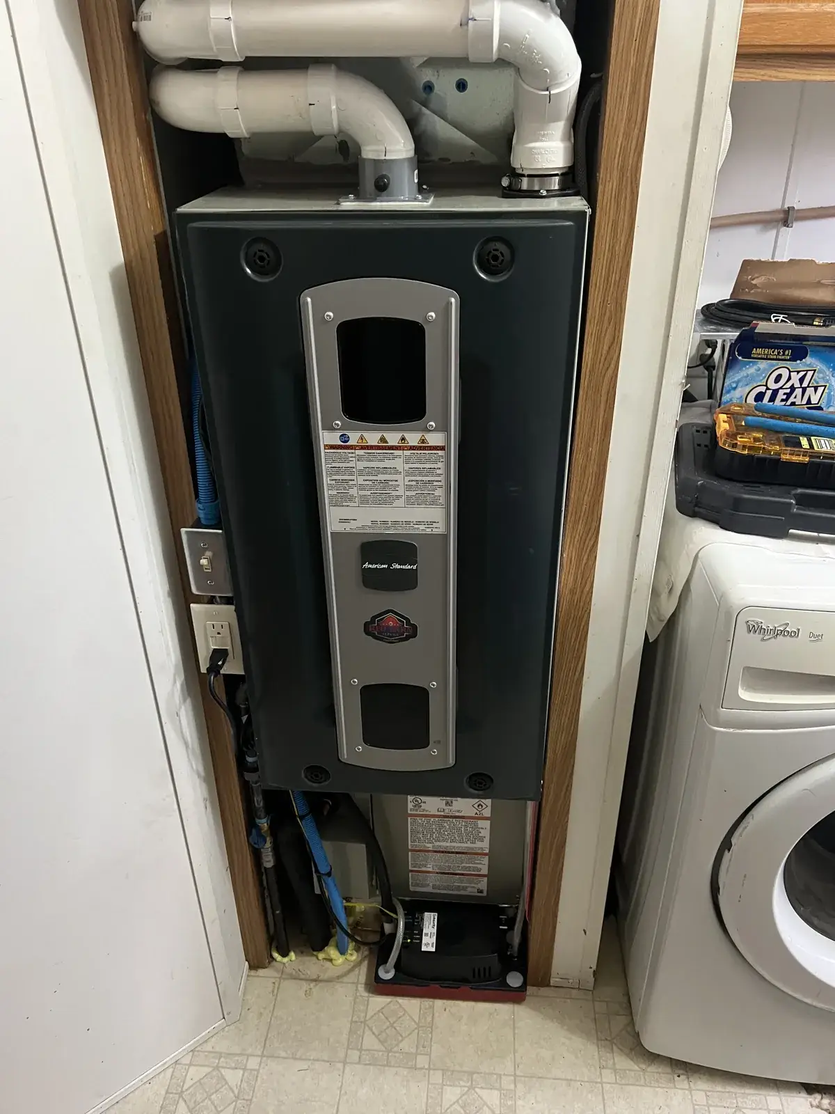 After — new American Standard furnace and coil fitted into a mobile home utility closet with a new condensate pump