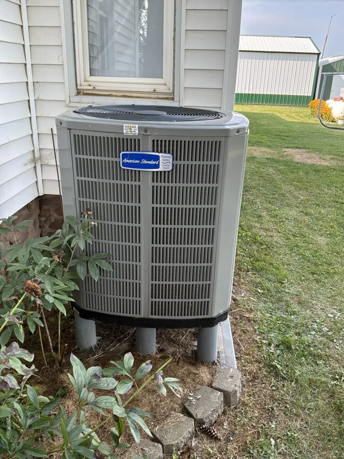 New American Standard Platinum Series condenser on risers, clear of the landscaping