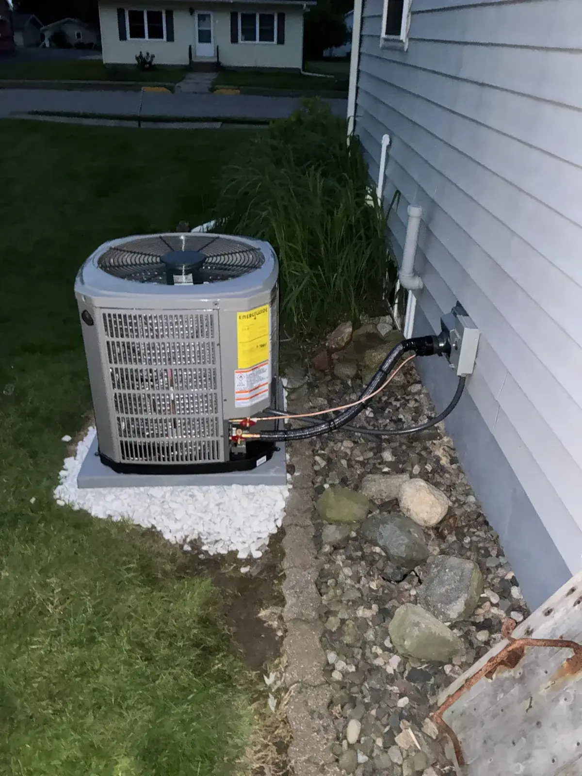 After — replacement condenser with new line set and disconnect finished out