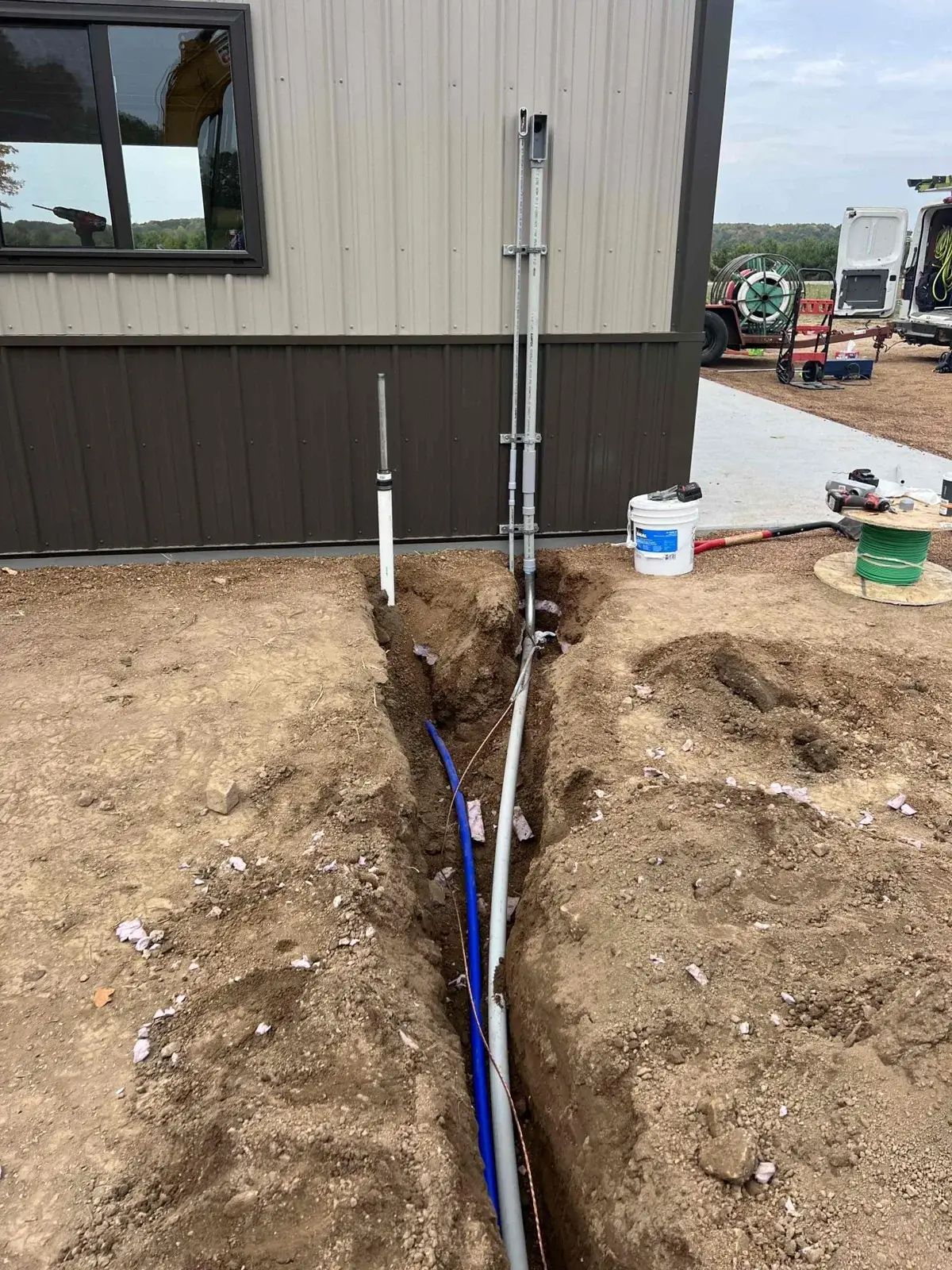 Conduits stubbed up and set at the building before backfill